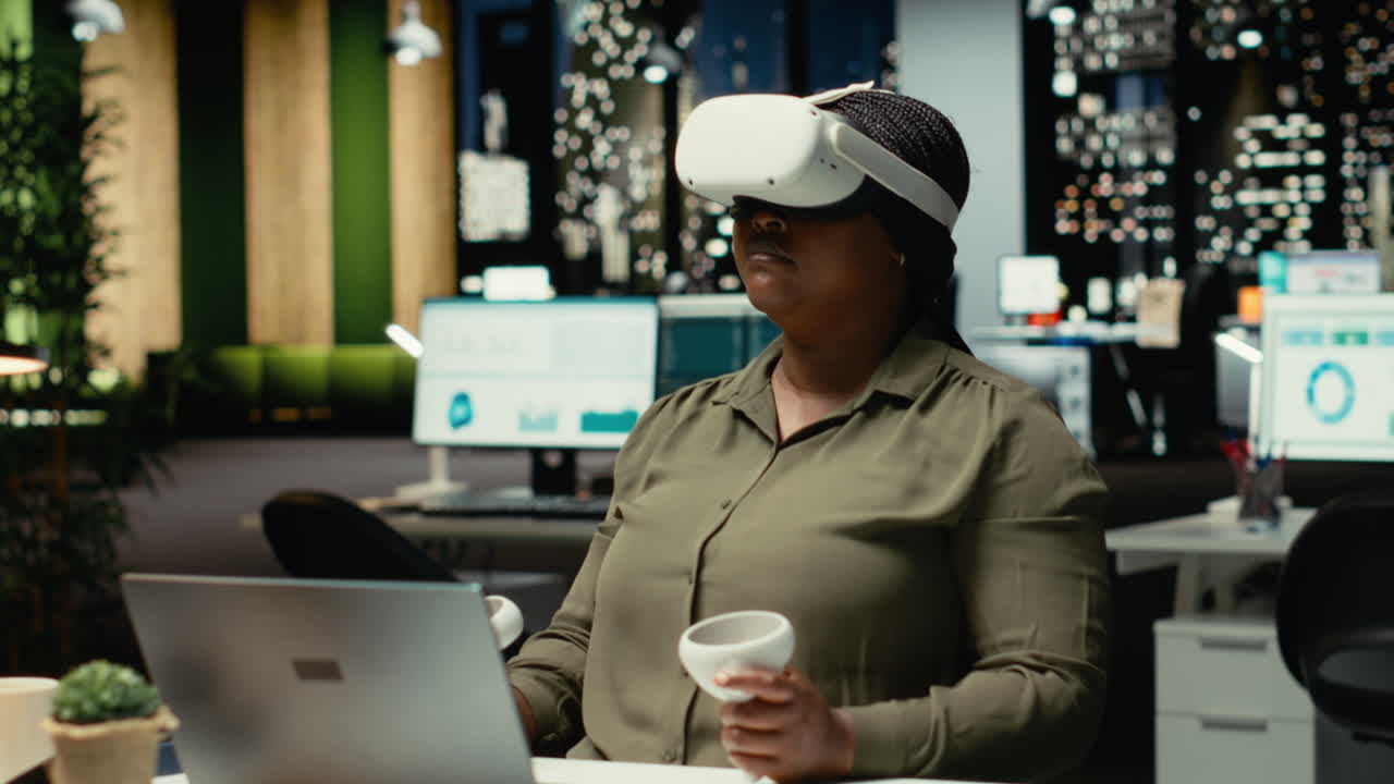 Young businesswoman using virtual reality headset and gadgets to draft a plan
