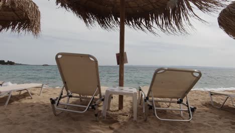 Exotic-sun-beds-and-umbrellas-at-a-beach-shore