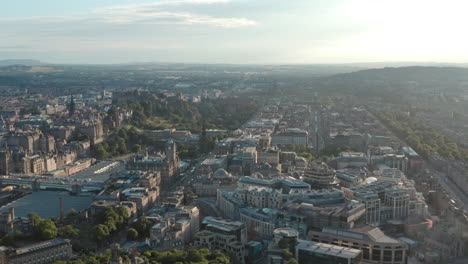 wide rising drone shot of edinburgh new town west end at sunset