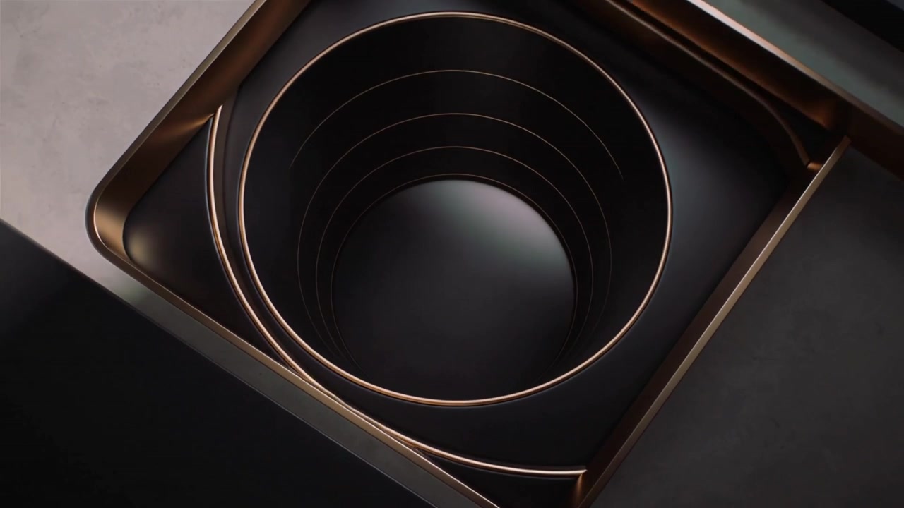 Telecamera che ruota, cornice che scorre, rivelando anelli concentrici in uno studio per una presentazione, finiture in bronzo.