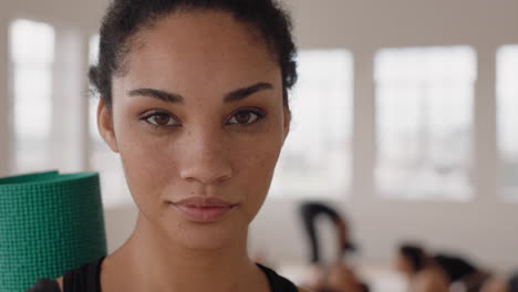 portrait beautiful yoga woman smiling confidently mixed race female enjoying healthy lifestyle with people practicing in fitness studio background