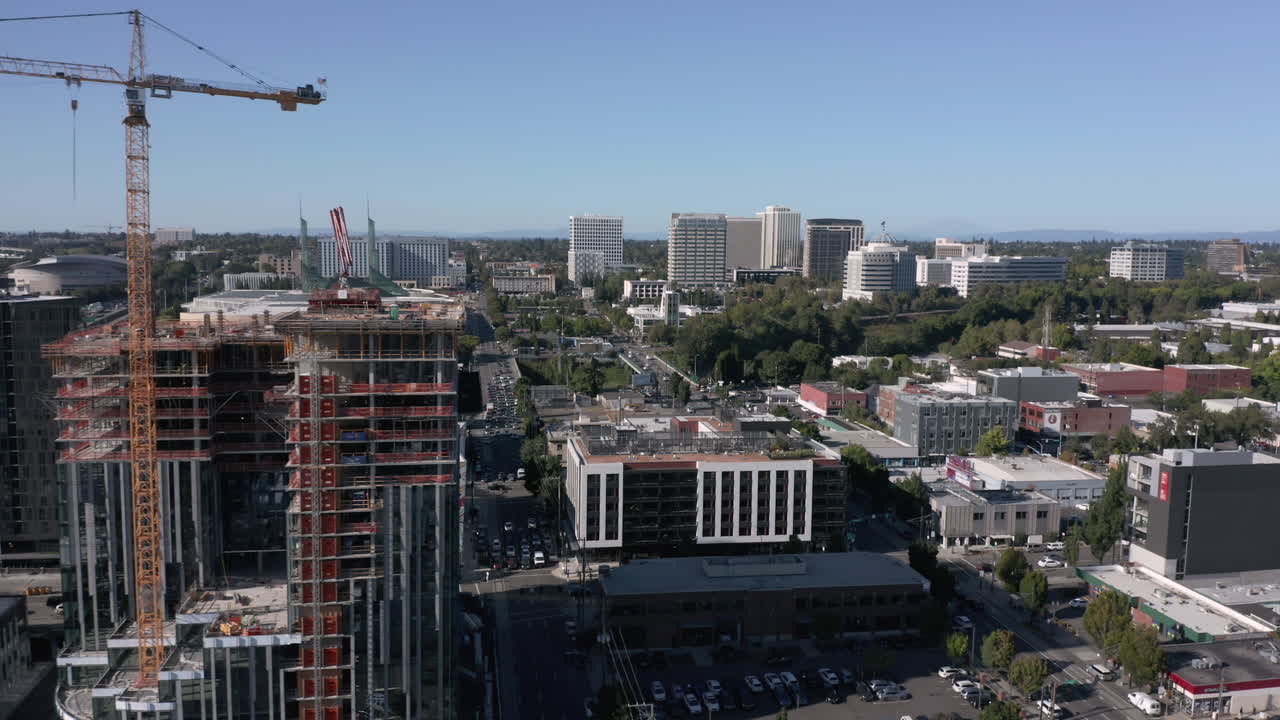 skyscraper crane and buildings in portland east side aerial dolly right