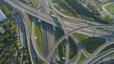 multi-level road junction and cars traffic. camera is tilting up. high altitude aerial vertical shot.