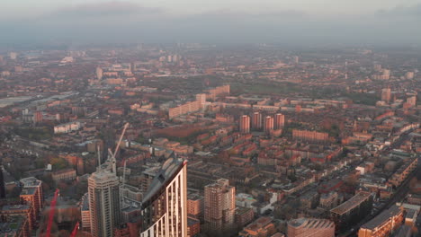 aerial shot over elephant and castle skyscrapers towards south london council estates