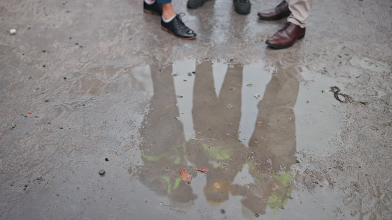 Reflection in a puddle of feet and legs