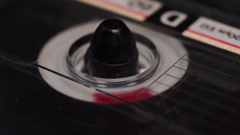 audio cassette tape from 1980s playing or recording from start, macro close up of spinning reel