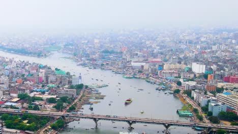 dhaka cityscape and burigana river port, ship terminal, aerial view