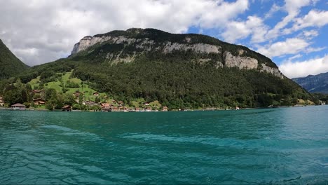 Trip-by-boat-along-buldings,-church-and-city-in-switzerland