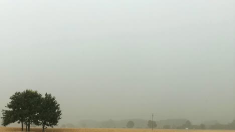 time lapse of heavy rain storm with clouds formation followed by a rainbow in the sky