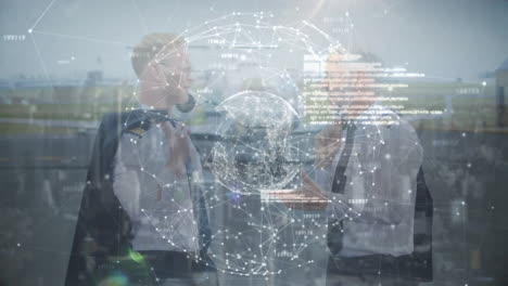 globe of network of connections against two caucasian pilots talking to each other at airport runway