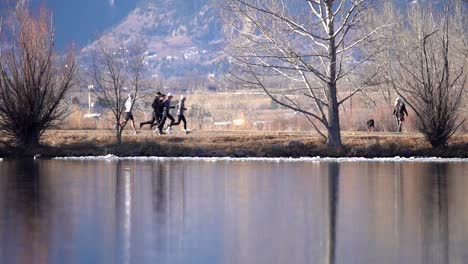 group of men running on a dirt road in countryside