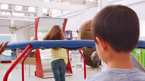 girl in a centrifugal force experiment at a science centre