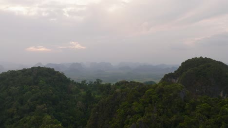 4k aerial drone footage of thai foggy mountains in krabi, thailand, asia, cloudy, dramatic