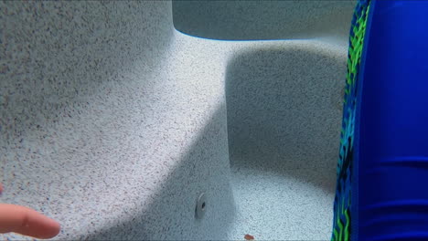 underwater perspective of a outdoor, above ground hot tub, with caucasian male's leg