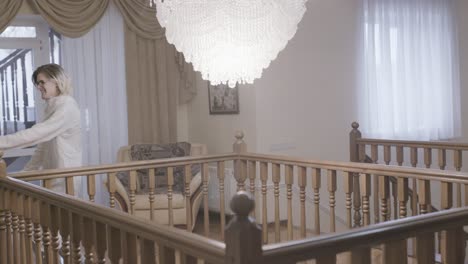 women dancing on a staircase in a luxurious home