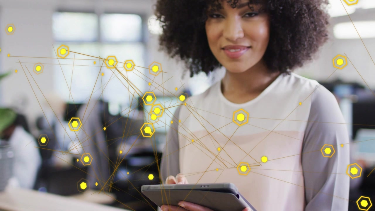 Woman tapping tablet after looking down, activating drifting yellow network overlay for tech demo