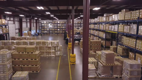 Aerial-shot-of-stacked-boxes-in-industrial-warehouse,-sideways-motion