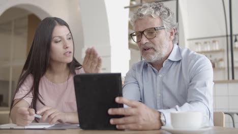 brunette businesswoman listening bearded colleague