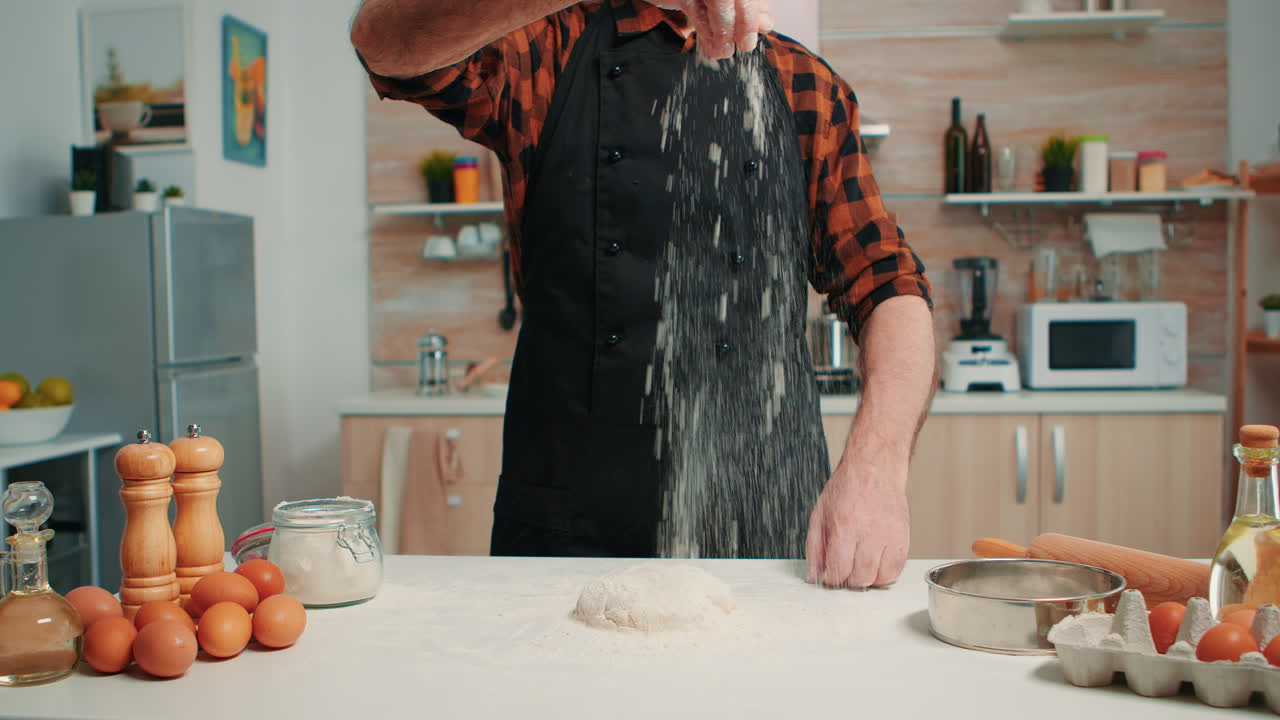 Bakery man sifting flour, preparing bread dough