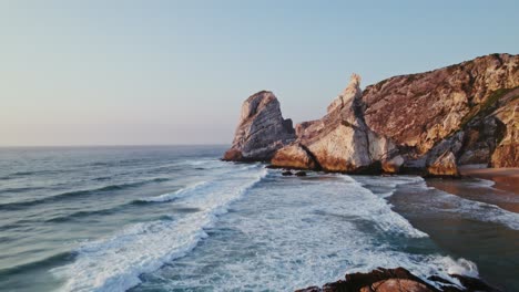 coastal rocks and waves at sunrise/sunset