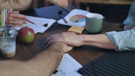 business men putting hands on table to connect with team at startup meeting