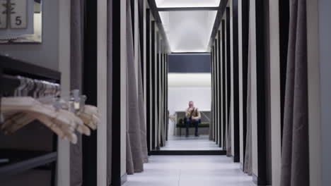 pathway between dressing rooms and man sitting on bench