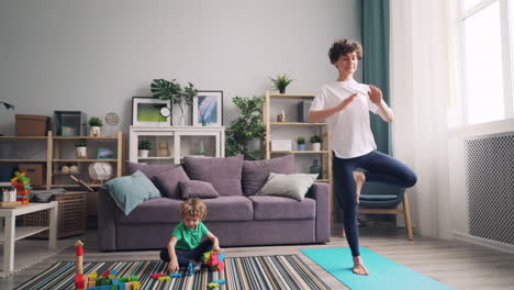 mother and child doing yoga at home