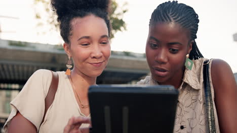 two women looking at a tablet