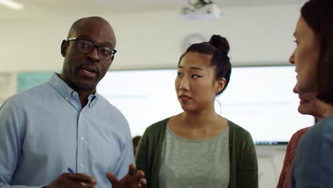 a group of professionals engages in a thoughtful discussion about teamwork and innovative approaches in a contemporary office space. the atmosphere is dynamic and inclusive.