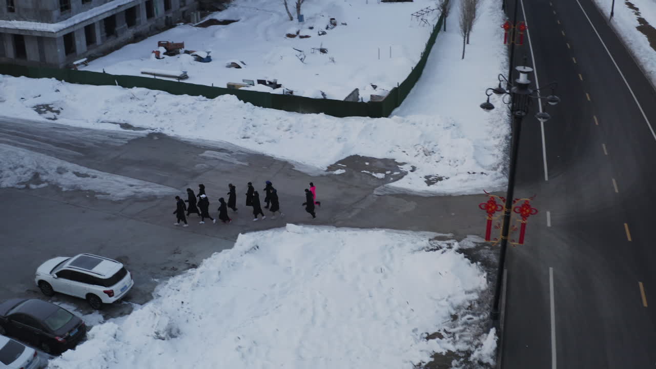Aerial view of a group dressed in black doing winter morning training