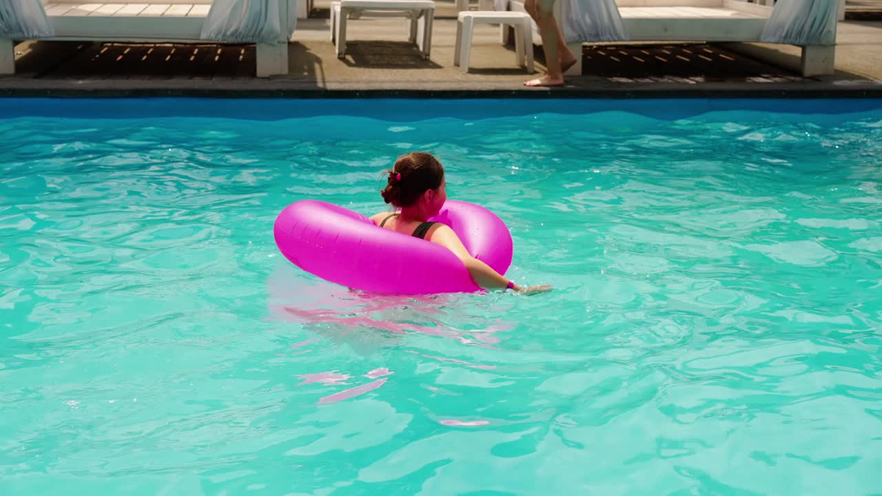 Child Swimming in Pool with Inflatable Ring