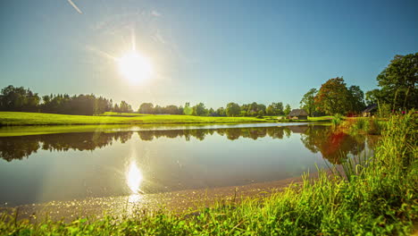 beautiful sunset over a lake with country house.