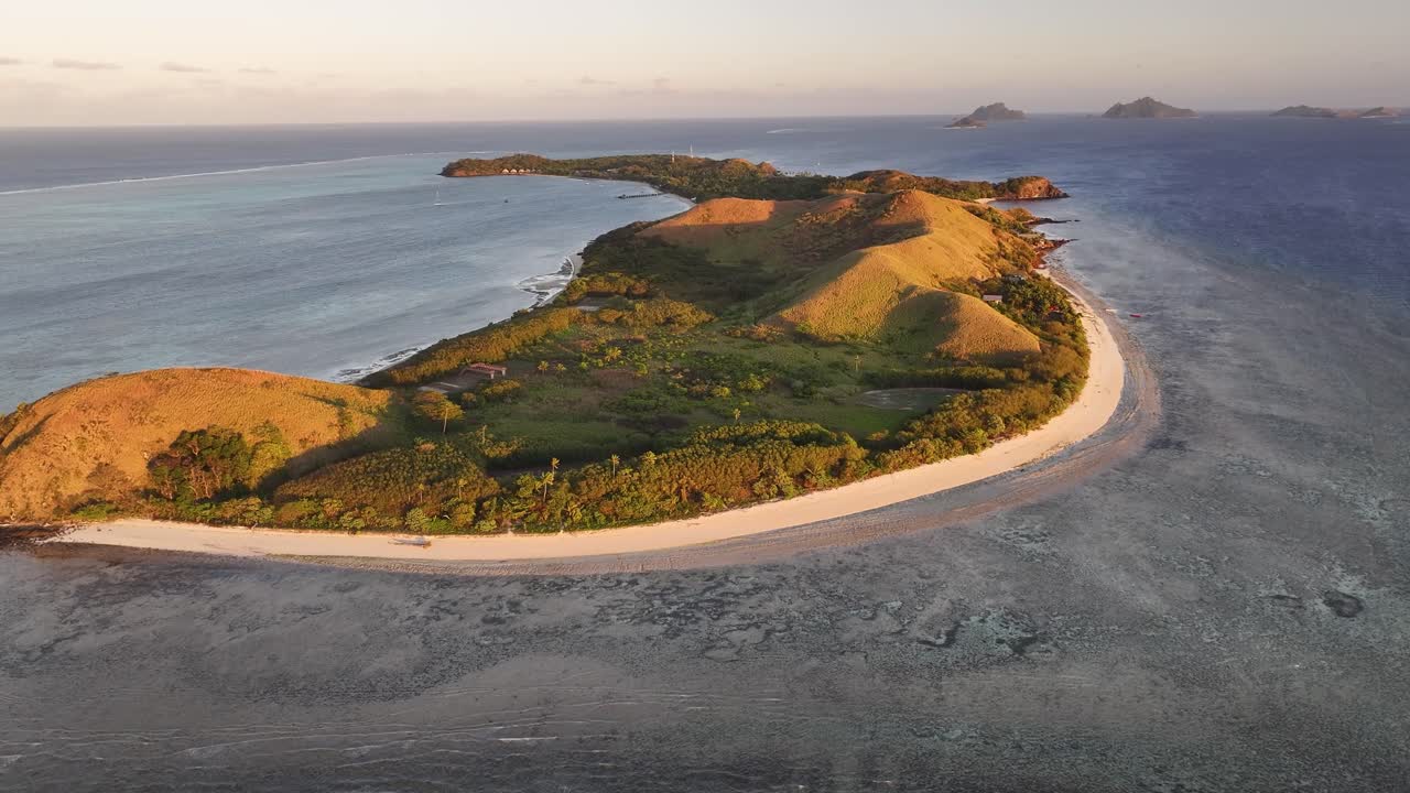Idyllic Mana Island in Fiji, golden light during sunset. Popular exotic get away and diving spot.