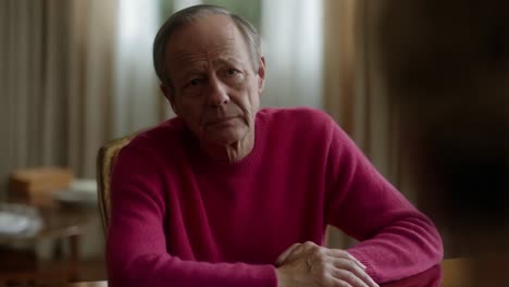 elderly man in pink sweater