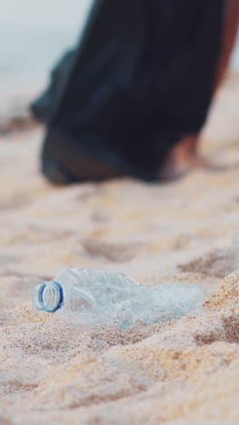 volunteer cleans beach of plastic pollution on bali island for a greener future