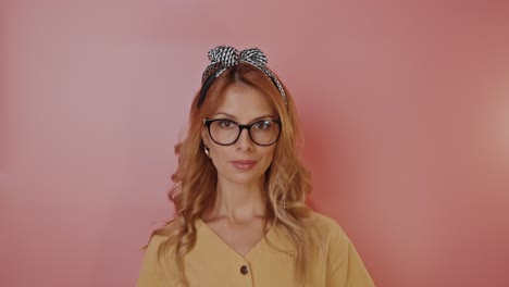 woman in a yellow shirt with glasses and headband