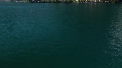 Ossuccio-on-lake-como-with-mountains-and-clear-skies,-aerial-view