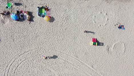 People-Enjoying-Warm-Sunshine-At-The-Sandy-Beach-By-The-Baltic-Sea-In-Summer