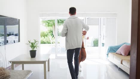 Happy-caucasian-couple-dancing-together-in-living-room,-slow-motion