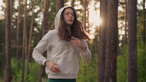 young woman running in a forest