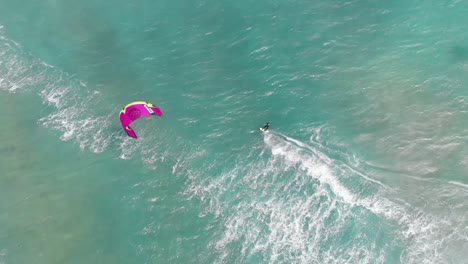 aerial view of kitesurfer in turquoise ocean