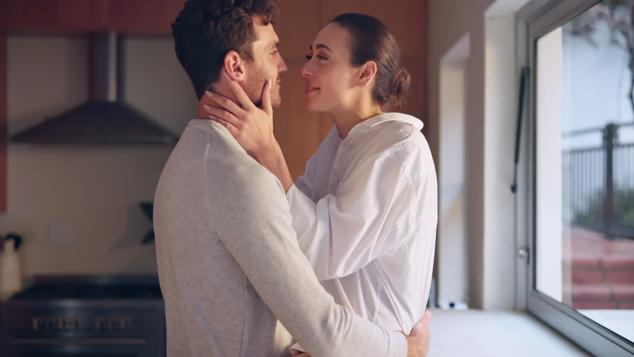 Hug, love or couple talking in kitchen
