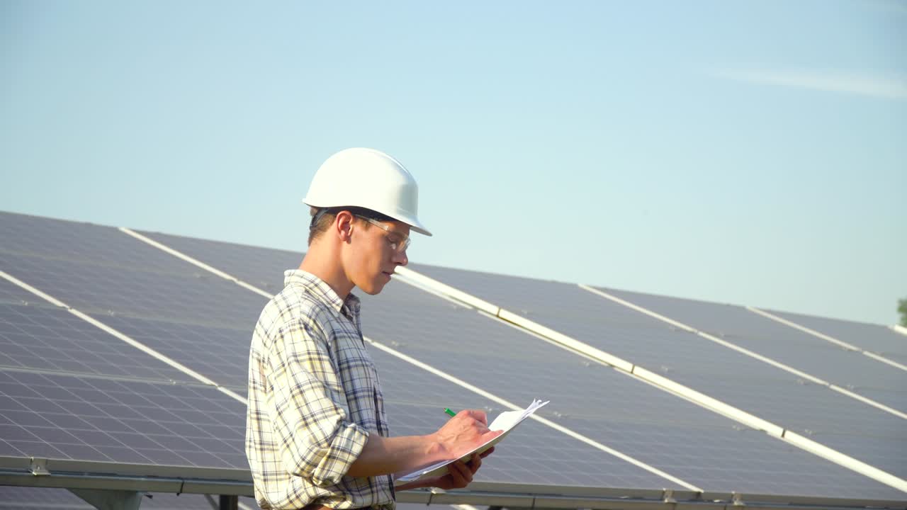 Engineer checks solar panels productivity. The green energy concept