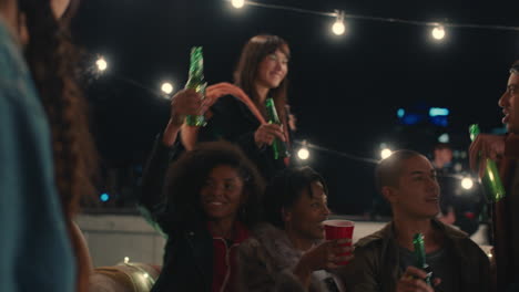 group of multi ethnic friends celebrating rooftop party making toast drinking enjoying reunion celebration on weekend social gathering at night