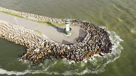 drone view from above of a lighthouse at sunrise