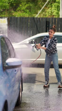 woman washing a car at a car wash