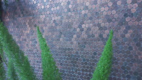 gimbal close-up booming up shot of the unique mosaic penny wall at the lucky penny pizza restaurant in the funk zone neighborhood of santa barbara, california. 4k