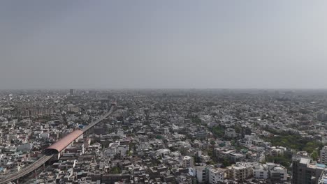 scenic overhead view of jaipur's densely populated areas where metro train passes through city