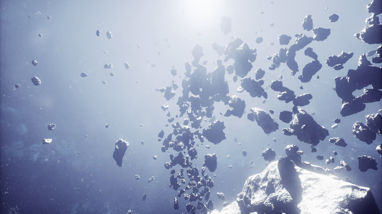 Asteroid belt floating in space with sunlight illuminating fragments