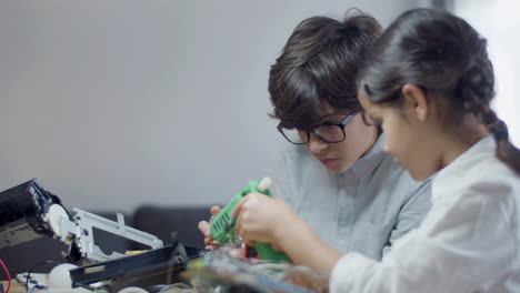 compagni di classe che fanno insieme progetti scolastici al chiuso con una lampadina